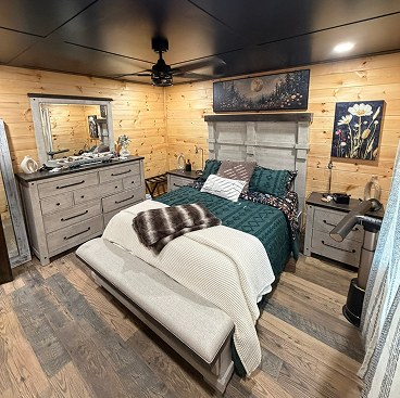 Cabin bedroom with pine walls and a king bed